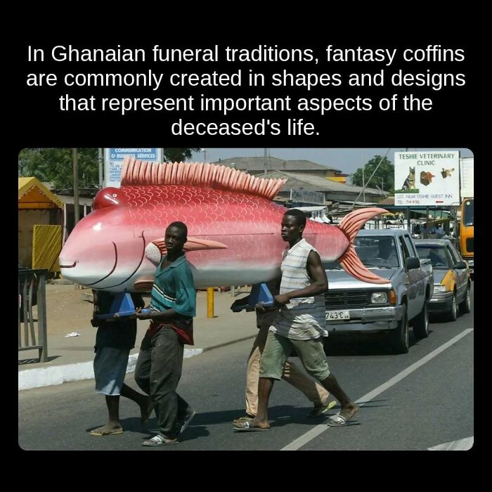 A large fish-shaped fantasy coffin carried by men in Ghana, showcasing an unseen fact about funeral traditions.