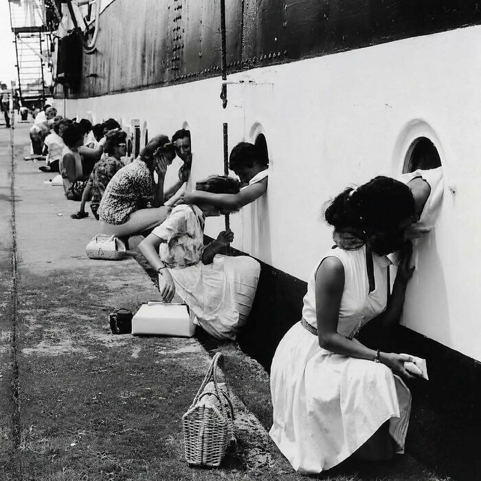 Women lining up beside a ship, peering through portholes, depicting a fascinating fact about travel.