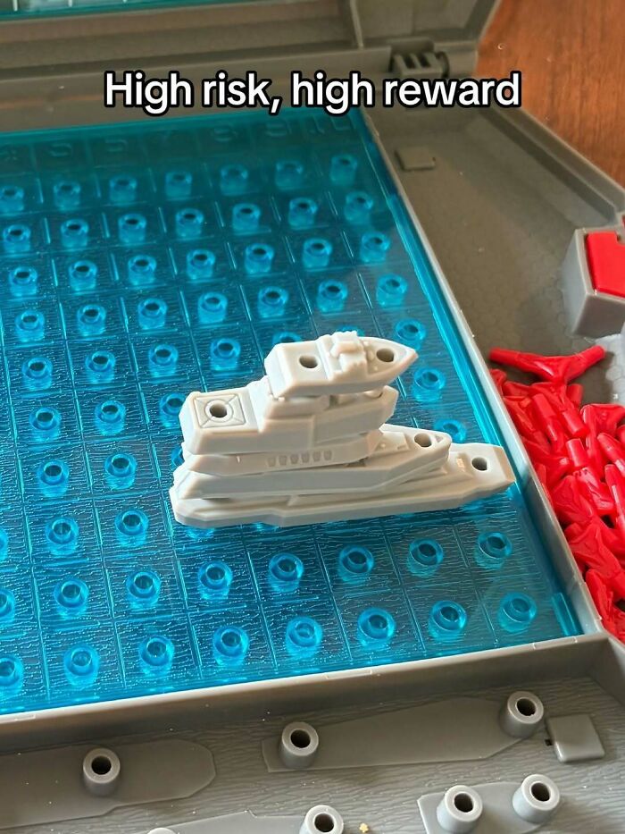 A cringe meme shows a Battleship game with all ships stacked together, titled High risk, high reward.