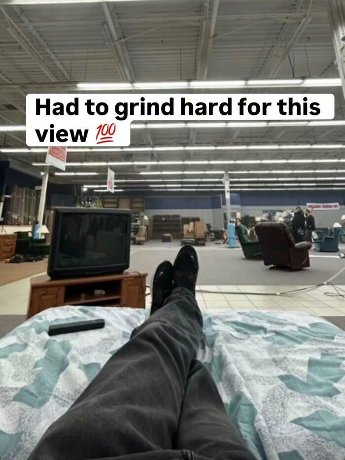 A painfully cringe post of someone relaxing on a mattress in an empty furniture store.