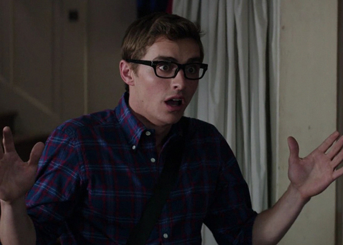 A behind-the-scenes image of an intimate scene with a man in glasses looking surprised.
