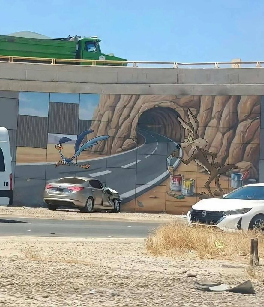 Funny screenshot of a car crash in front of a mural depicting Wile E. Coyote and Road Runner, showing weird internet humor.