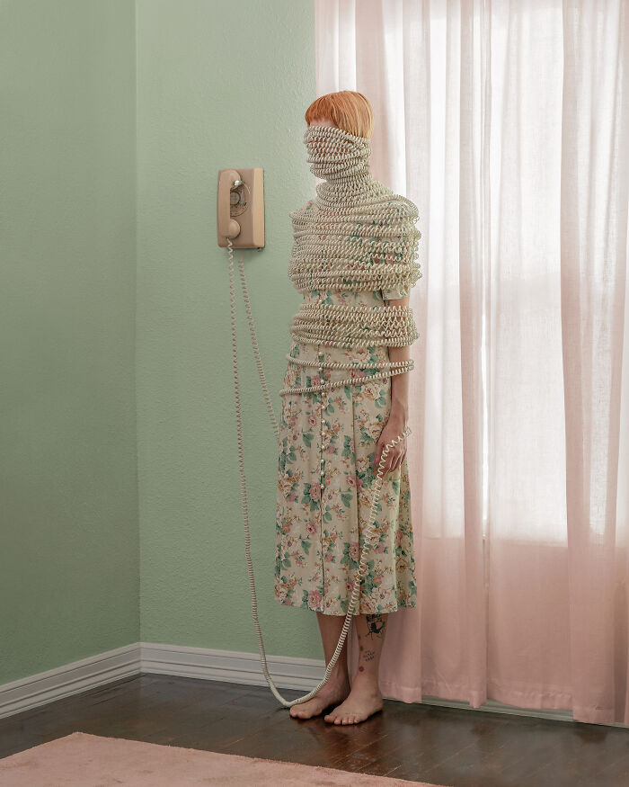 A photographer creates surreal images of a person wrapped in a telephone cord in a pastel room. Everyday places.