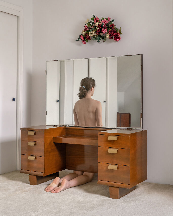 A photographer creates surreal images; a woman kneels in front of a vanity table, her reflection visible in the mirror.