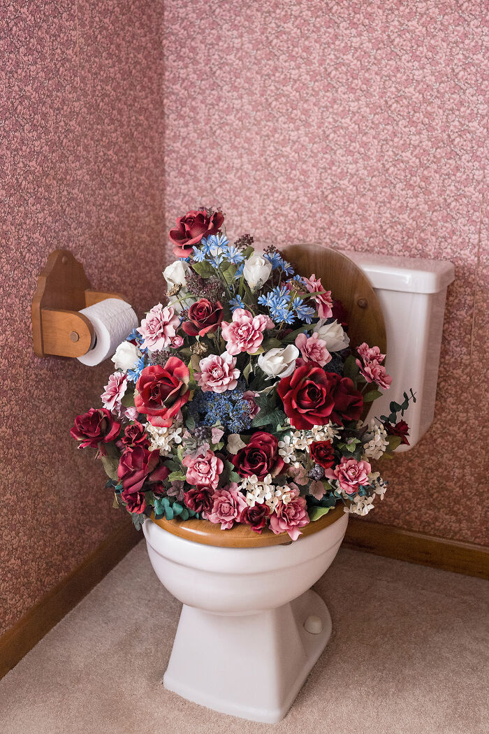 A photographer creates surreal images; a toilet is overflowing with a vibrant arrangement of artificial flowers.