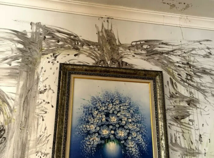 Looksmaxxer's wall with a painting, marred by black and grey streaks from the bizarre incident.