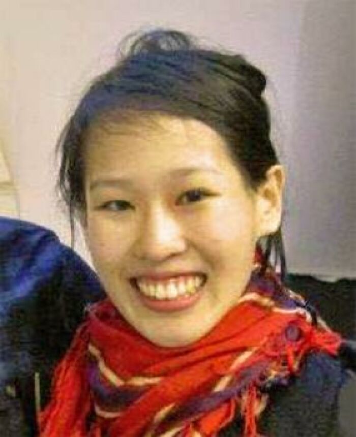A close-up of a smiling young woman wearing a red scarf, related to unsolved mysteries.