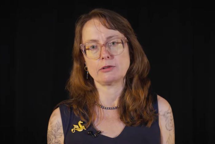 Emily Wilson, The Odyssey translator, on a black background, discussing Nolan's adaption blunder.