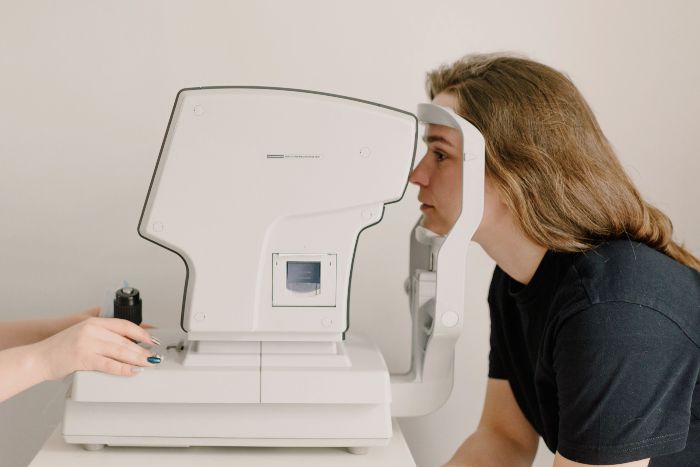 Woman undergoing an eye exam, with an expert explaining the routine eye exam procedures. Woman undergoing an eye exam, with an expert explaining the routine eye exam procedures.