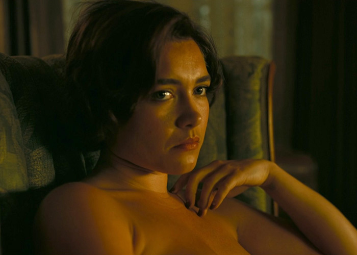 A woman in an intimate scene, looking intently, showing behind-the-scenes chaos.