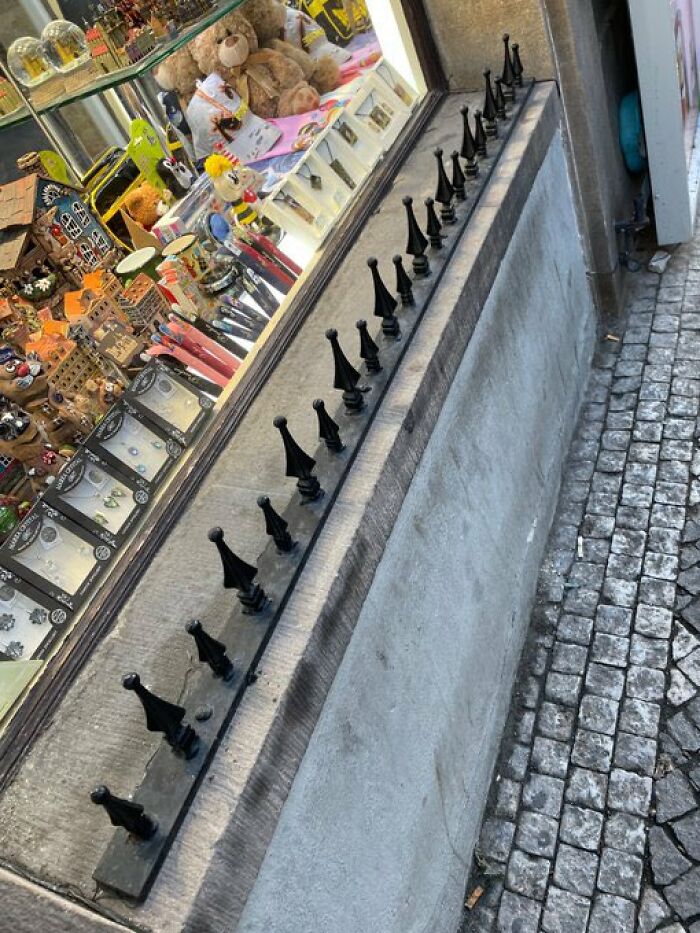 Spikes on a window ledge, an example of urban design not considering people's comfort.