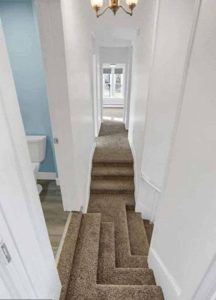 A narrow, zig-zagging staircase leads to a hallway, illustrating poor urban design and lack of people's comfort.