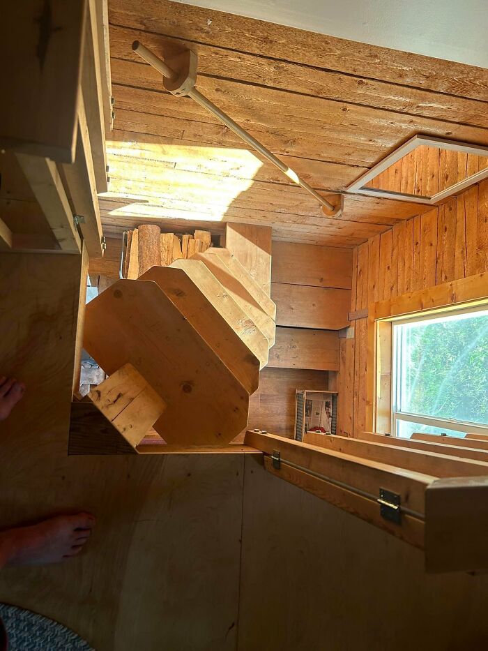 A narrow, steep wooden staircase in a small space, an example of urban designers forgetting people's comfort.