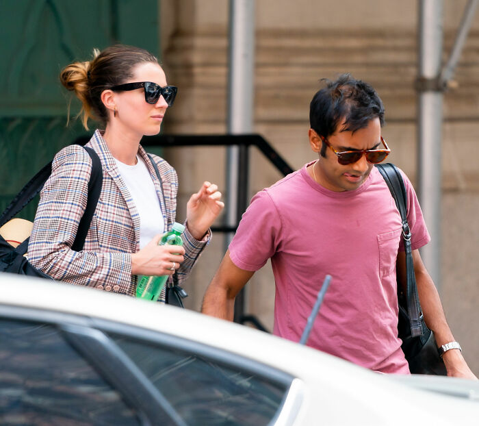 Aziz Ansari and his wife walking outdoors, amid discussions regarding his lifestyle and marriage. Aziz Ansari and his wife walking outdoors, amid discussions regarding his lifestyle and marriage.