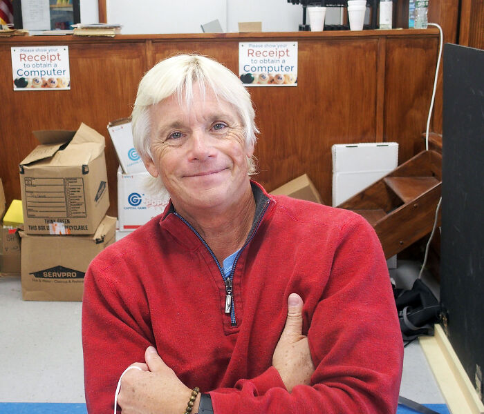 Actor Christopher Atkins smiling, looking at the camera, wearing a red sweater, with arms crossed. Blue Lagoon actor. Actor Christopher Atkins smiling, looking at the camera, wearing a red sweater, with arms crossed. Blue Lagoon actor.