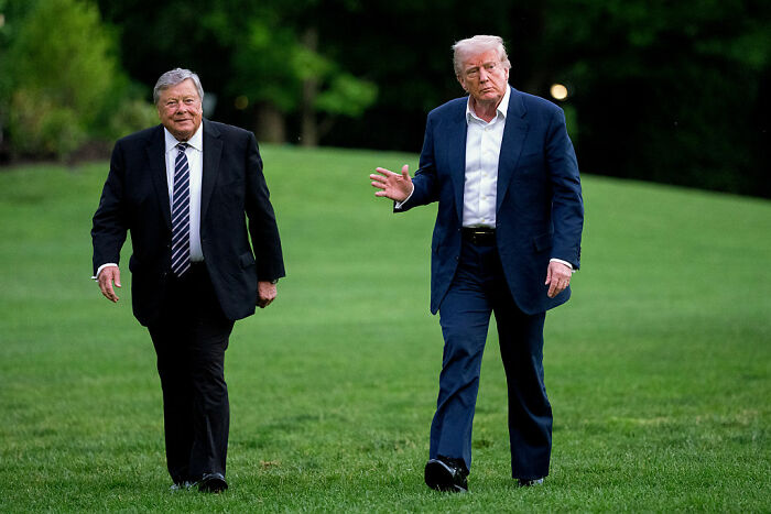 Donald Trump walking alongside another man, fueling body double conspiracy theory discussions. Donald Trump walking alongside another man, fueling body double conspiracy theory discussions.