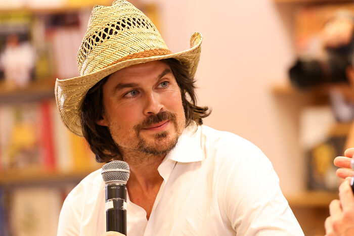 Teen heartthrob, Ian Somerhalder, in a straw hat, smiling with a microphone, after he quit Hollywood.