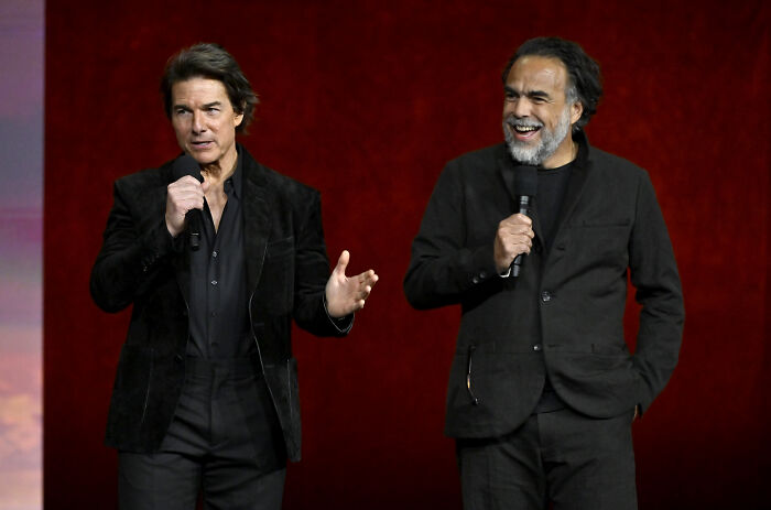 Tom Cruise and a colleague discussing his incredible transformation, an Oscar-worthy achievement.
