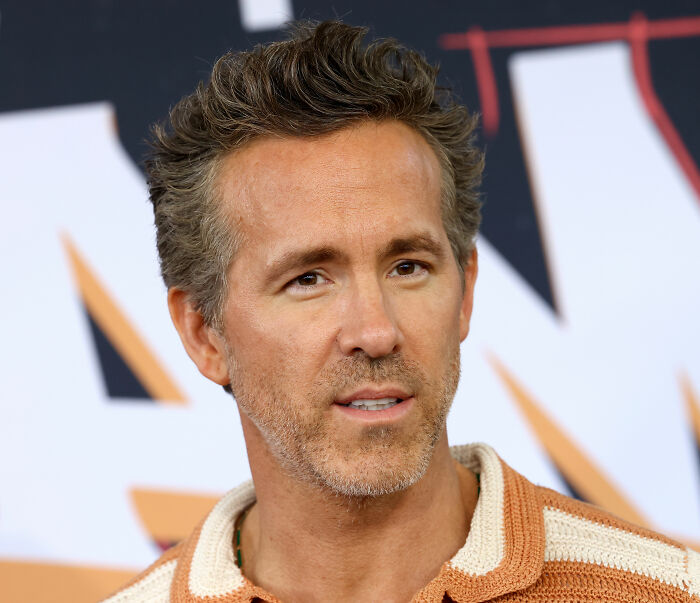 Close-up of Ryan Reynolds facing Hollywood backlash, projects falling apart, but not blacklisted.