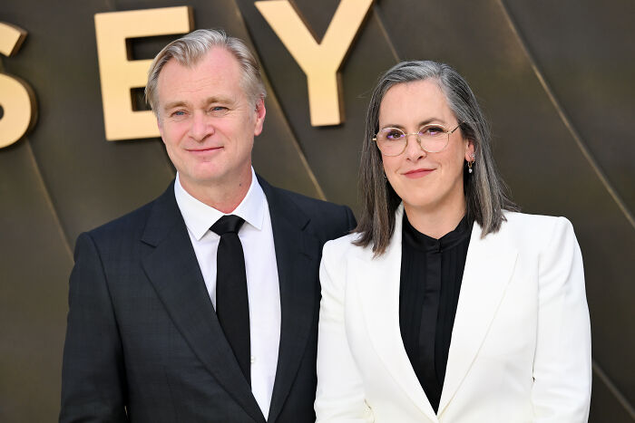 Christopher Nolan and Emma Thomas, the creative force behind 'The Odyssey,' standing together, addressing film fans. Christopher Nolan and Emma Thomas, the creative force behind 'The Odyssey,' standing together, addressing film fans.