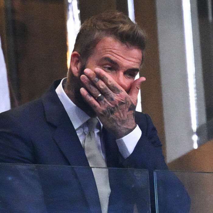 David Beckham covers his face with his tattooed hand, expressing emotion about Victoria Beckham's behavior. David Beckham covers his face with his tattooed hand, expressing emotion about Victoria Beckham's behavior.
