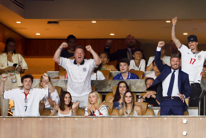 David Beckham and fans celebrating, showing behavior that contrasts with Victoria Beckham's recent actions. David Beckham and fans celebrating, showing behavior that contrasts with Victoria Beckham's recent actions.