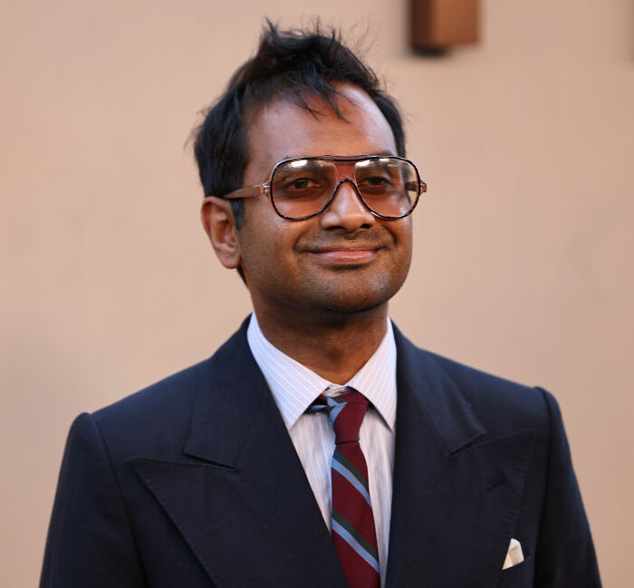 Aziz Ansari looking stylish in glasses and a suit, sparking discussion about his lifestyle and marriage. Aziz Ansari looking stylish in glasses and a suit, sparking discussion about his lifestyle and marriage.