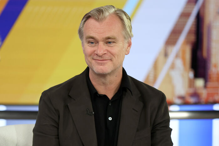 Close-up of Christopher Nolan smiling, wearing a dark shirt and jacket. Christopher Nolan's bizarre rules on set. Close-up of Christopher Nolan smiling, wearing a dark shirt and jacket. Christopher Nolan's bizarre rules on set.