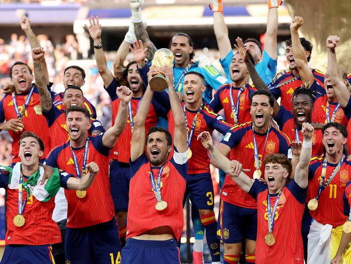 Spanish players celebrating their World Cup Final victory, holding the trophy, contrasting with Messi's controversial move. Spanish players celebrating their World Cup Final victory, holding the trophy, contrasting with Messi's controversial move.