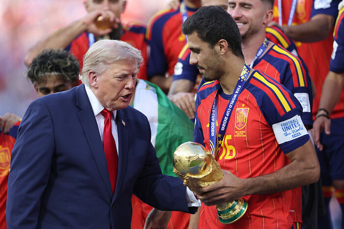 Donald Trump at FIFA World Cup Final in New York speaking to a player holding the trophy. Donald Trump at FIFA World Cup Final in New York speaking to a player holding the trophy.