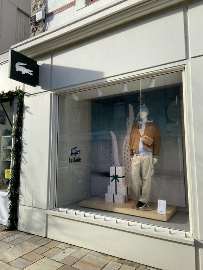 Urban designers forgot peoples comfort, with a display of Lacoste clothing in a shop window.