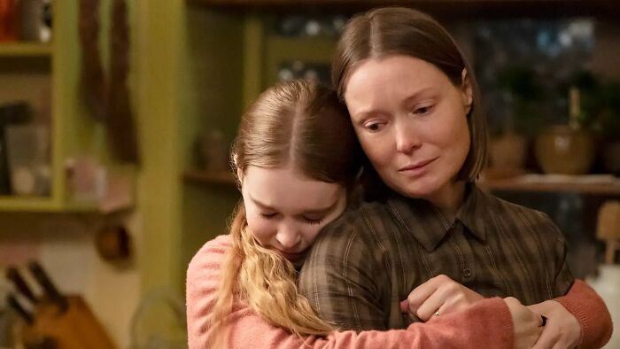 A woman with short brown hair embracing a young girl with long blonde hair, evoking emotions related to Stephen King's horror classic reboot. A woman with short brown hair embracing a young girl with long blonde hair, evoking emotions related to Stephen King's horror classic reboot.