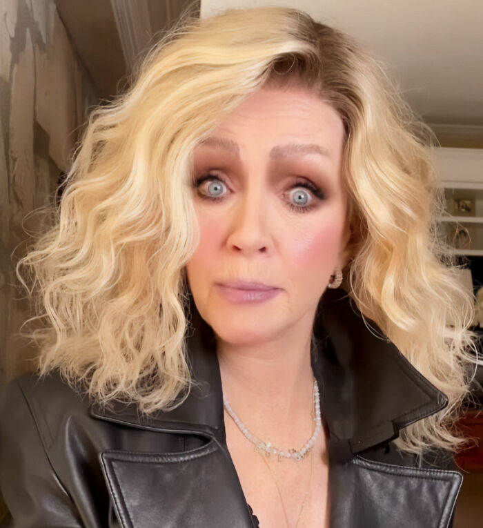 A close-up of a Hollywood star with blonde hair and wide blue eyes, wearing a black leather jacket. A close-up of a Hollywood star with blonde hair and wide blue eyes, wearing a black leather jacket.