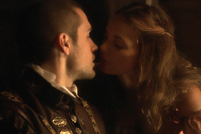 A man and woman kissing in an intimate scene, revealing behind-the-scenes chaos.