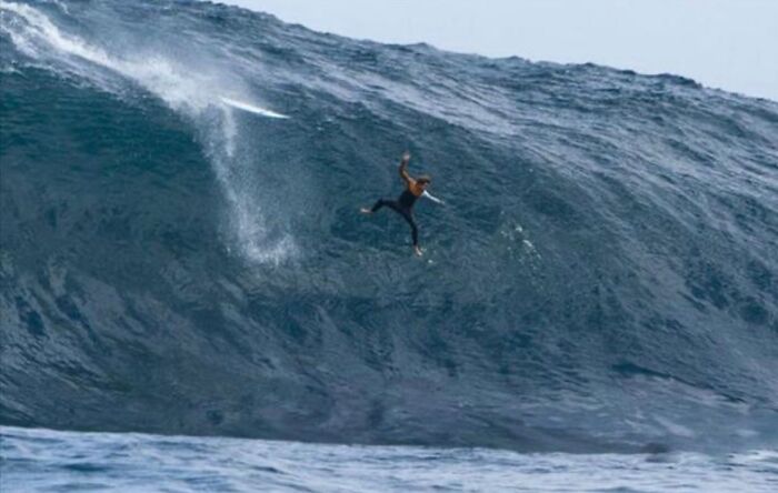 Hilarious photo of a surfer falling off a giant wave, moments before disaster.