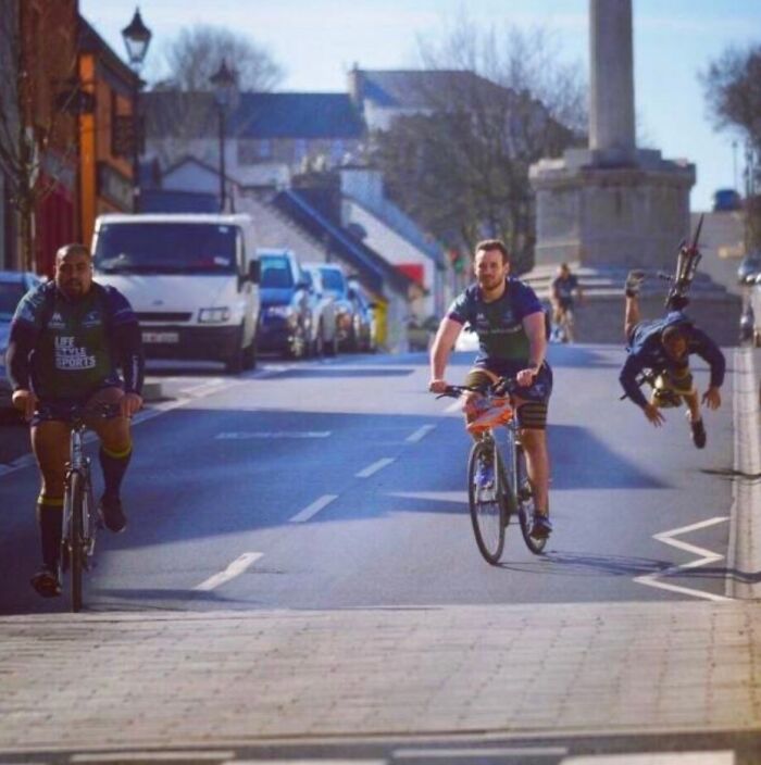 Hilarious photo of cyclists on a street, one rider airborne moments before disaster.