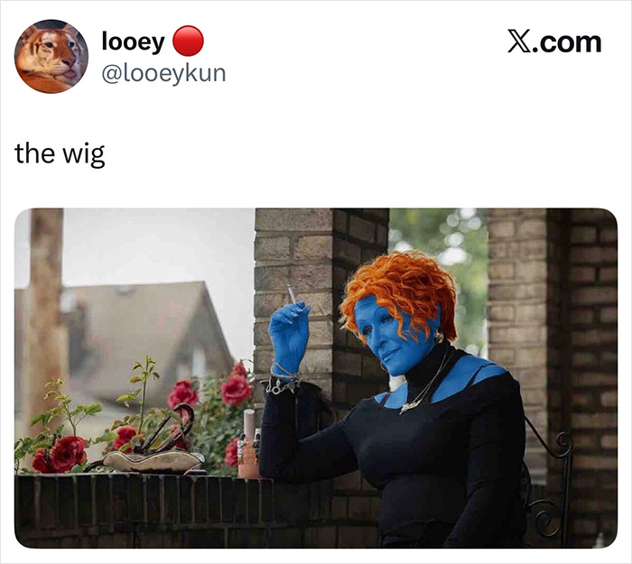 A woman with blue skin and a red wig smoking a cigarette, showing a Hollywood blockbuster mistake.