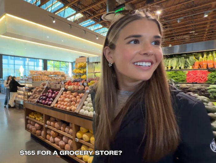 Kai Trump at a grocery store, looking around with a surprised expression during her ESPYs interview.