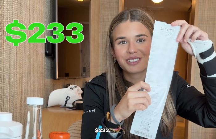 Kai Trump holds up a long grocery receipt with a surprised expression during her ESPYs interview.