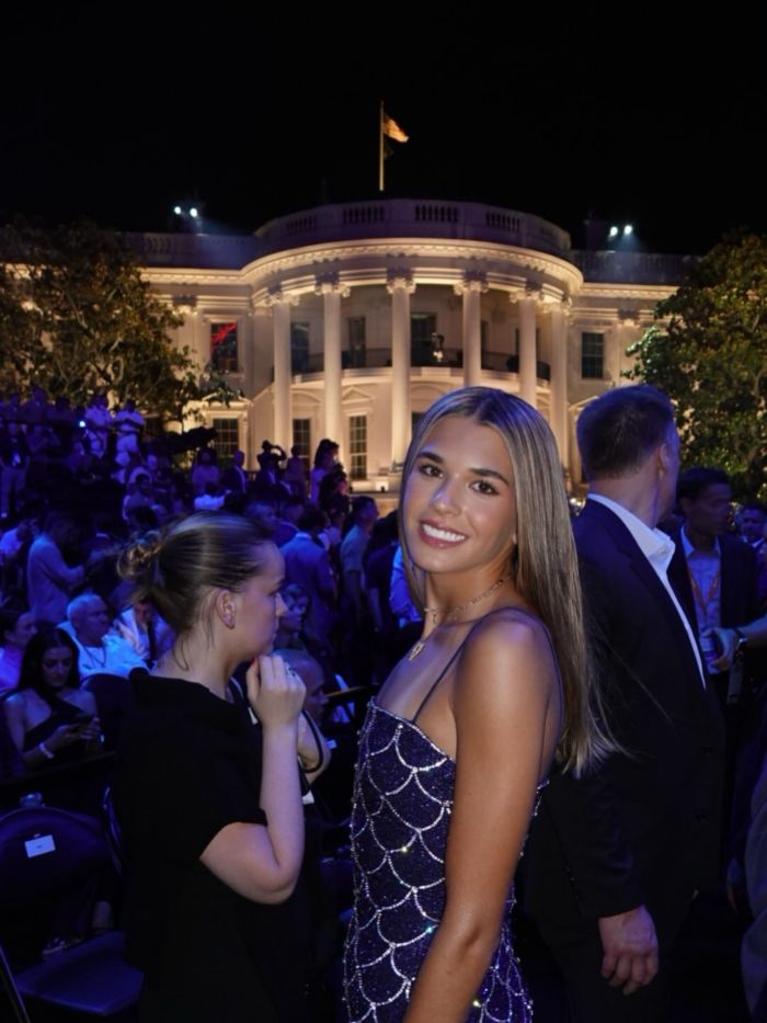 Kai Trump at an ESPYs event, smiling with the White House in the background during the cringe interview.