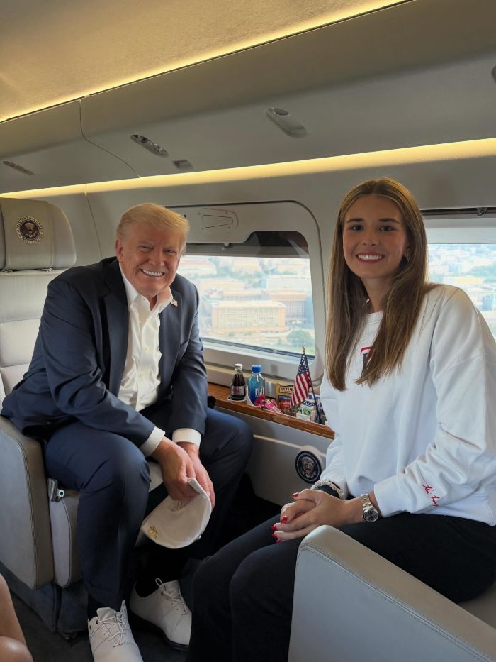 Kai Trump sits next to Donald Trump on a private jet, smiling at the camera for her ESPYs interview.