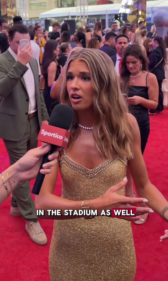 Kai Trump interviewed on a red carpet, wearing a gold dress at an ESPYs event, before her cringe interview.