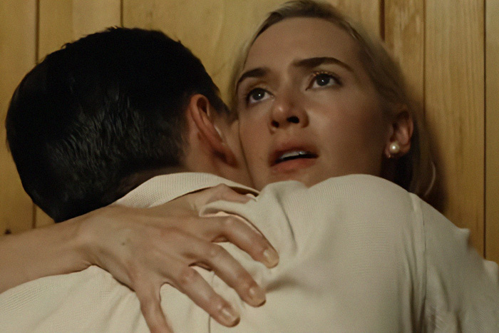Close moment between two actors during an intimate scene behind the scenes