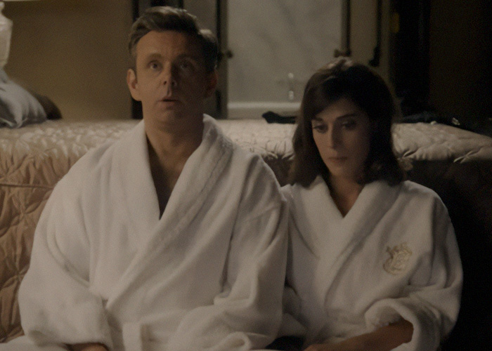 Actors in white robes preparing for an intimate scene behind the scenes