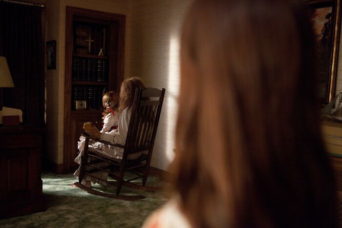 A terrifying Annabelle doll in a rocking chair, adding to the most terrifying horror movies.