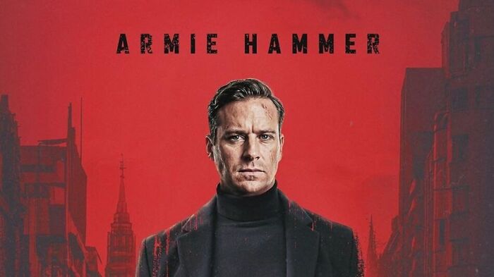 Armie Hammer's comeback film promotional image, featuring him with a serious expression against a red backdrop with city silhouettes. Armie Hammer's comeback film promotional image, featuring him with a serious expression against a red backdrop with city silhouettes.