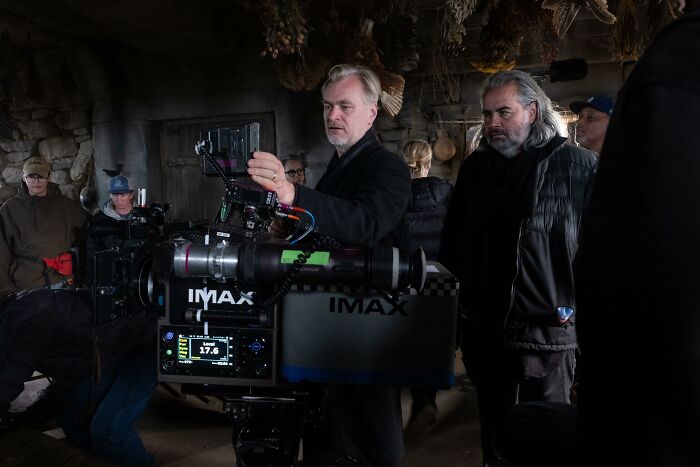 A director and crew filming with a large IMAX camera, relevant to The Odyssey movie production and reviews.
