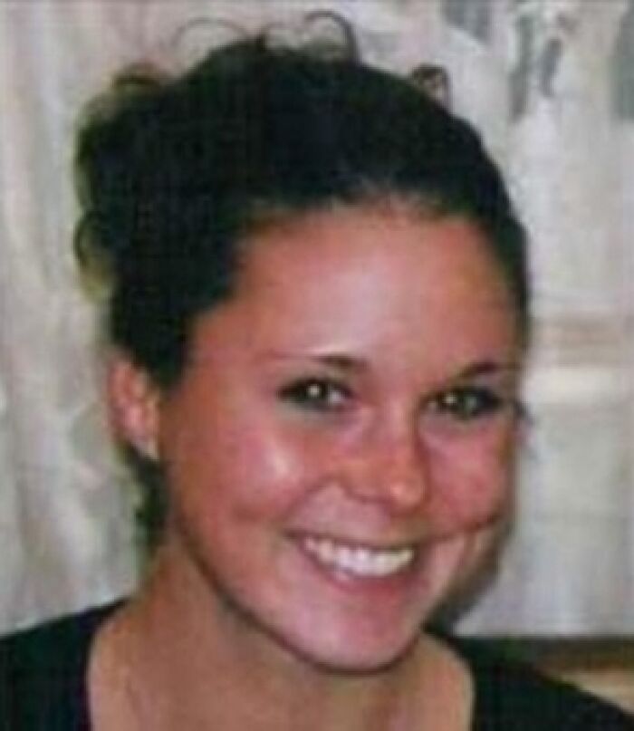A young woman with brown hair pulled back, smiling at the camera, related to unsolved mysteries.