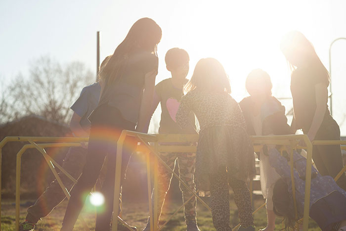 Ohio House of Horrors: Children playing on playground equipment with bright sunshine, contrasting with the dark title. Ohio House of Horrors: Children playing on playground equipment with bright sunshine, contrasting with the dark title.