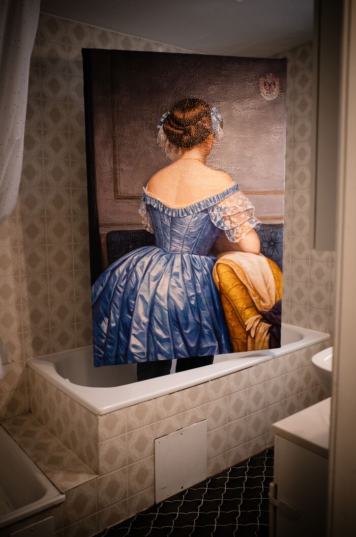 Artist reimagined a famous masterpiece from behind, featuring a woman in a blue gown with intricate hair.
